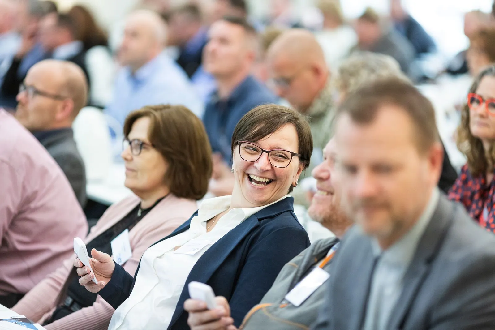 Conference attendees listening to a speaker