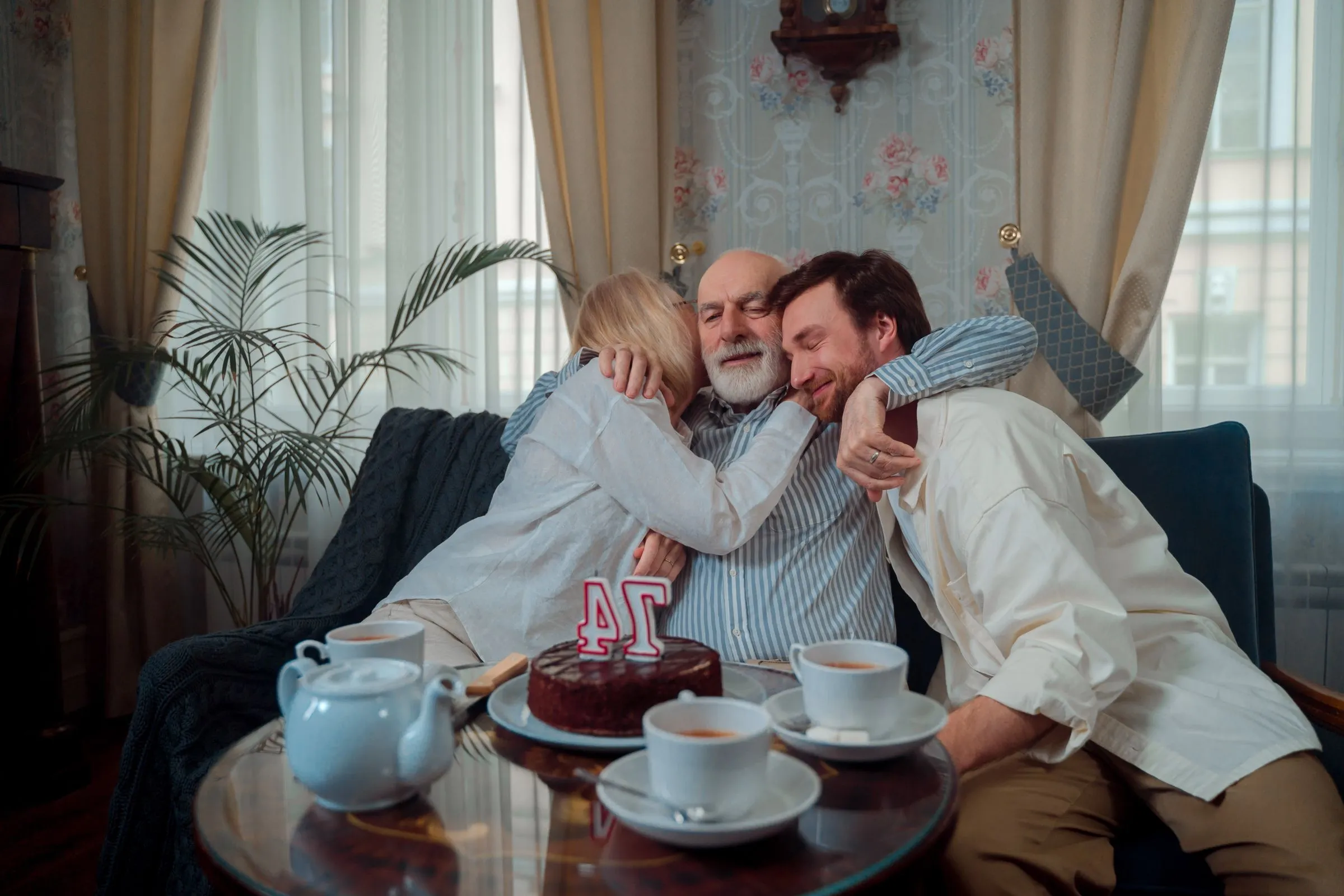 A family sharing a warm, joyful moment with an older relative