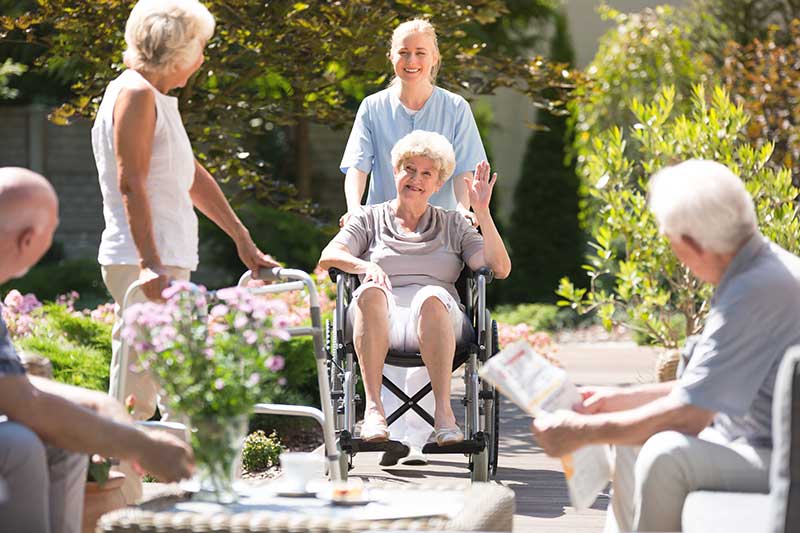 delegation in nursing retired people in garden - Engagement Through Education | Assisted Living Classes