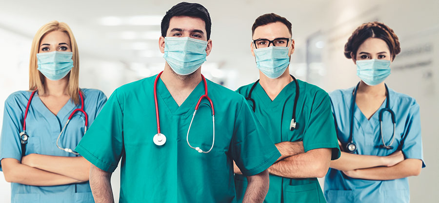nursing shortage nursing standing in a line in scrubs with masks