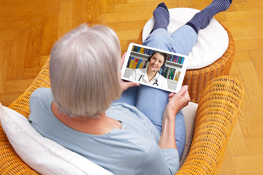 telehealth elderly woman on telehealth ipad appointment - Engagement Through Education | Assisted Living Classes