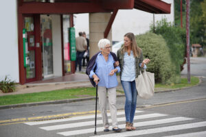 help seniors young woman walking with senior lady