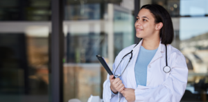 nursing leadership, bi-racial nurse standing with clipboard
